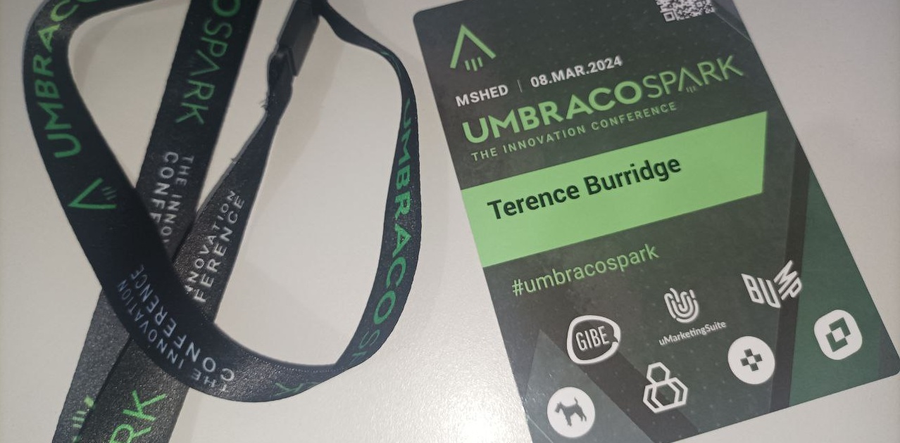 UmbracoSpark 2024 Badge and Lanyard in their green colourscheme, showing the sponsors and attendee name too.